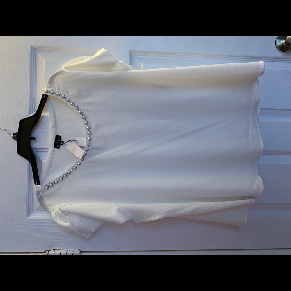 White blouse with design on chest